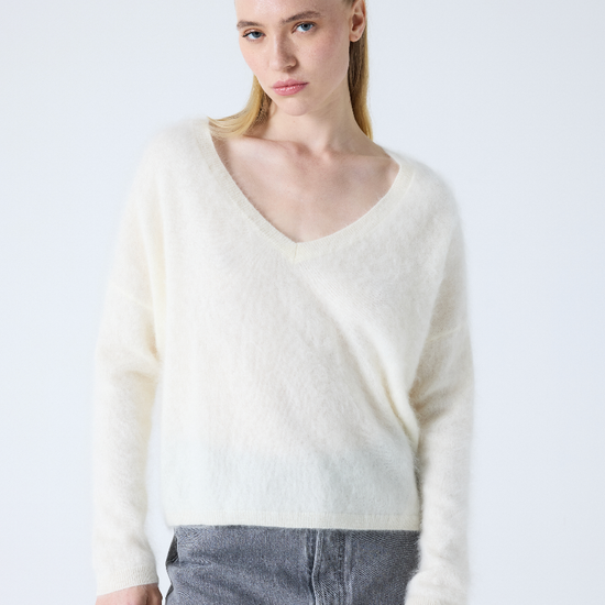 cream v neck jumper with long sleeves and fluffy texture