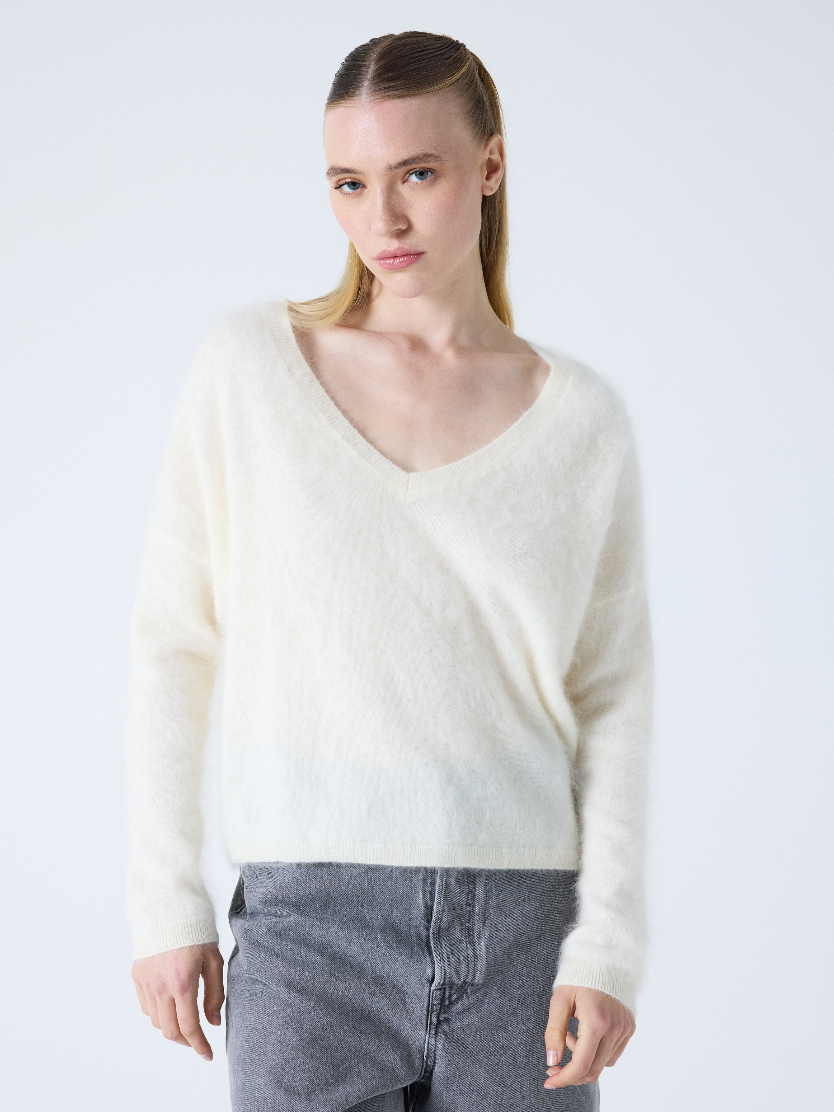 cream v neck jumper with long sleeves and fluffy texture