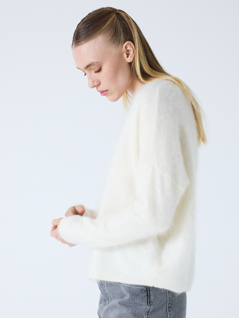 cream v neck jumper with long sleeves and fluffy texture side view
