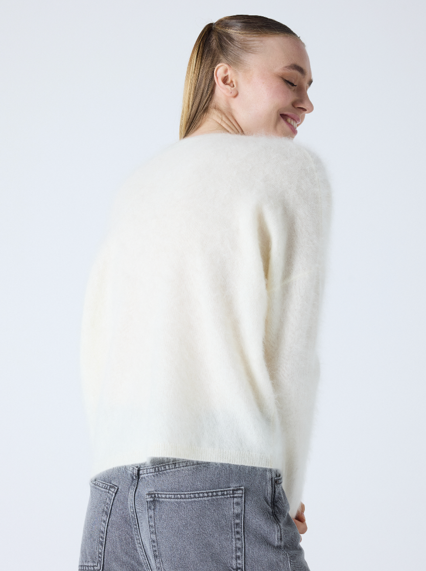 cream v neck jumper with long sleeves and fluffy texture rear view 