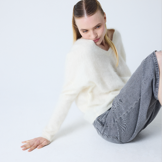 cream v neck jumper with long sleeves and fluffy texture model shot