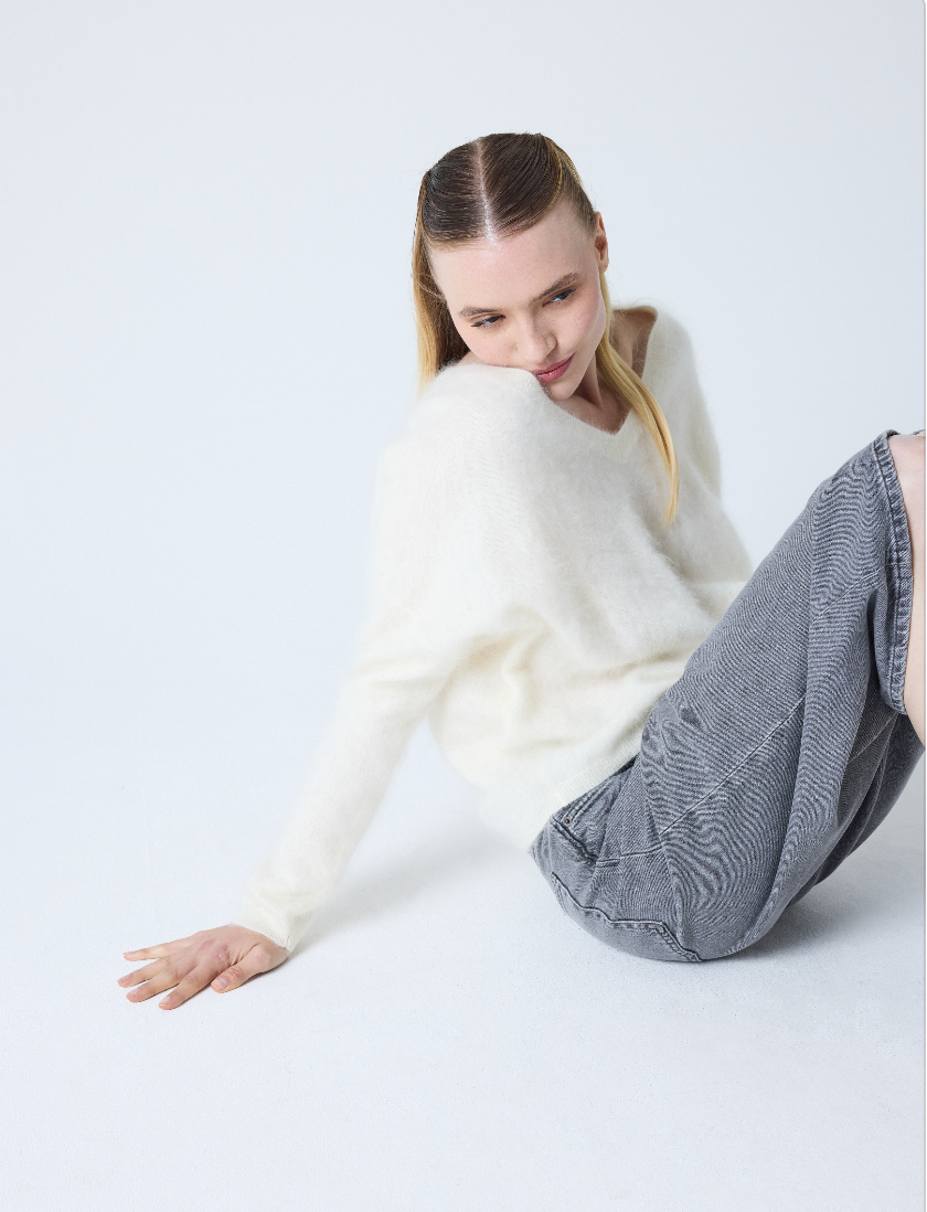 cream v neck jumper with long sleeves and fluffy texture model shot