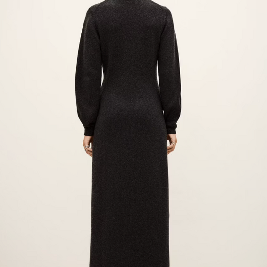 charcoal grey knitted long dress with round neck, ruche detailing with a statement crystal brooch and balloon sleeves rear view