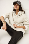 beige hoodie with gold zip sides and drawstring neck from ba&sh model shot