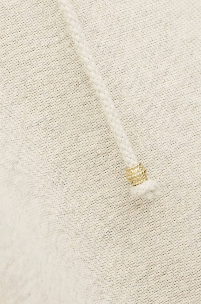 beige hoodie with gold zip sides and drawstring neck from ba&sh close up