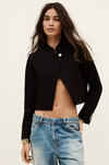 cropped black jacket with asymmetric placket and singular gold button from bash model shot