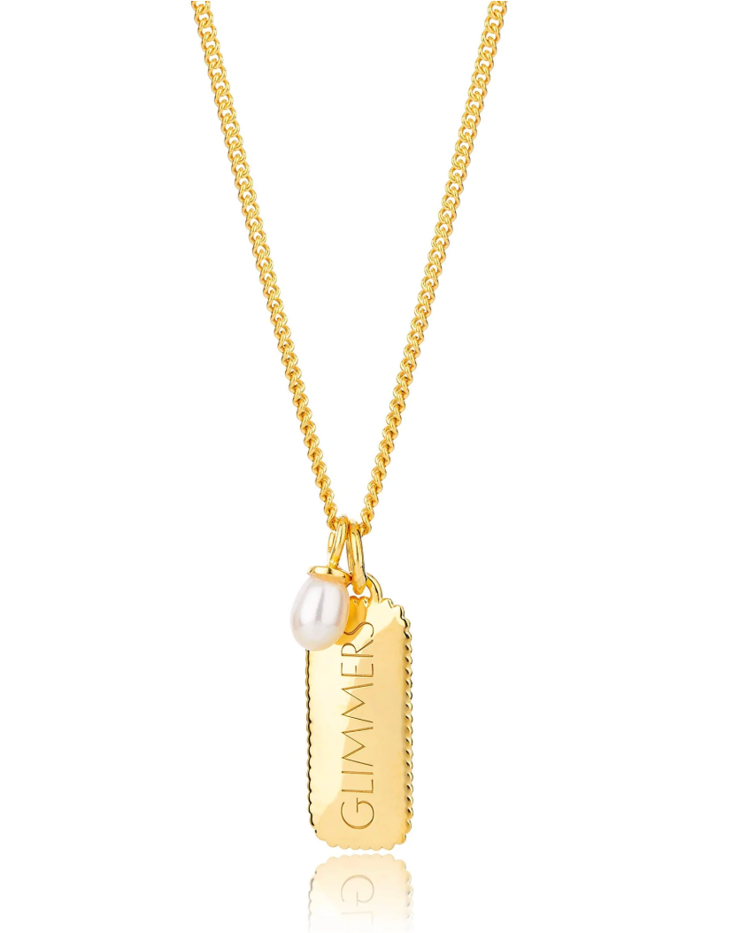 rectangular gold pendant with heart on one side and glimmer written on the other with pearl from claudia bradby reverse side