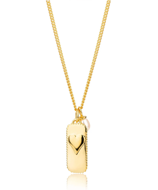 rectangular gold pendant with heart on one side and glimmer written on the other with pearl from claudia bradby