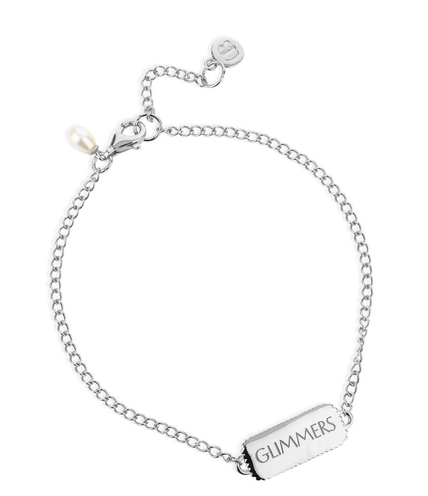 silver bracelet with rectangular pendant with a heart on one side and glimmers written on the other from claudia bradby reverse side