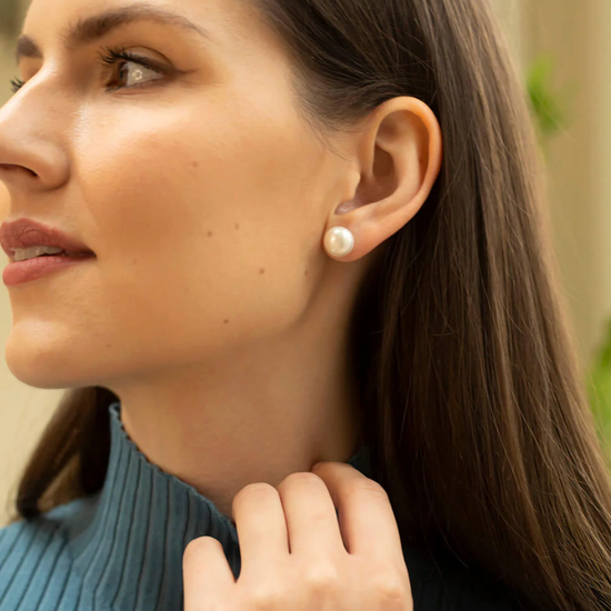 large white pearl studs from claudia bradby model shot