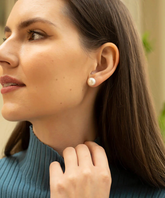 large white pearl studs from claudia bradby model shot