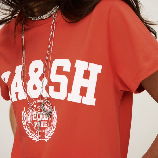 ned tshirt with white bash on the front  close up