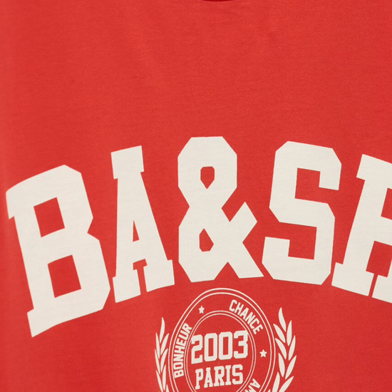 ned tshirt with white bash on the front  close up