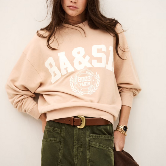 light pink long sleeve sweatshirt with white bash on the front model