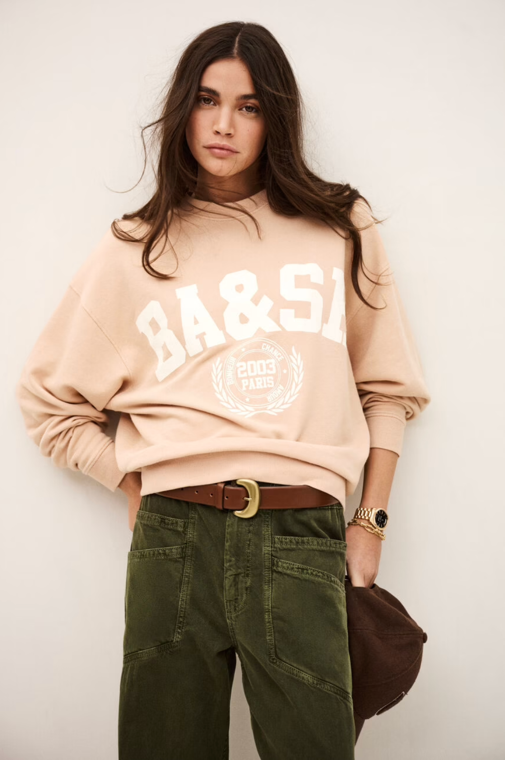 light pink long sleeve sweatshirt with white bash on the front model