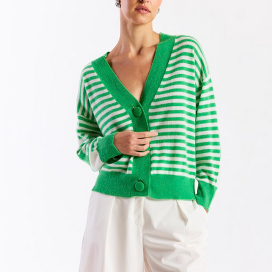 Woman wearing a green and white striped cardigan on a white background