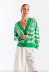 Woman wearing a green and white striped cardigan on a white background