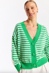 Woman wearing a green and white striped cardigan on a white background