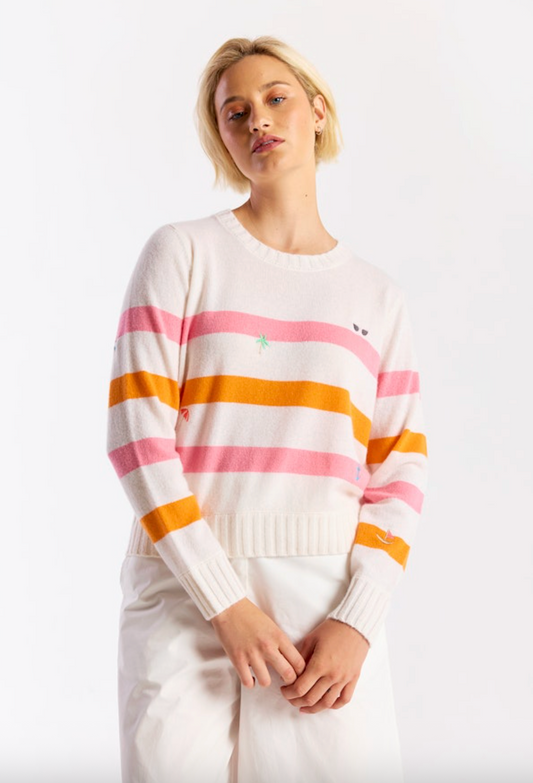 Woman wearing a striped sweater with a white background