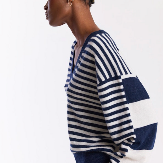 Woman wearing a blue and white striped sweater on a white background