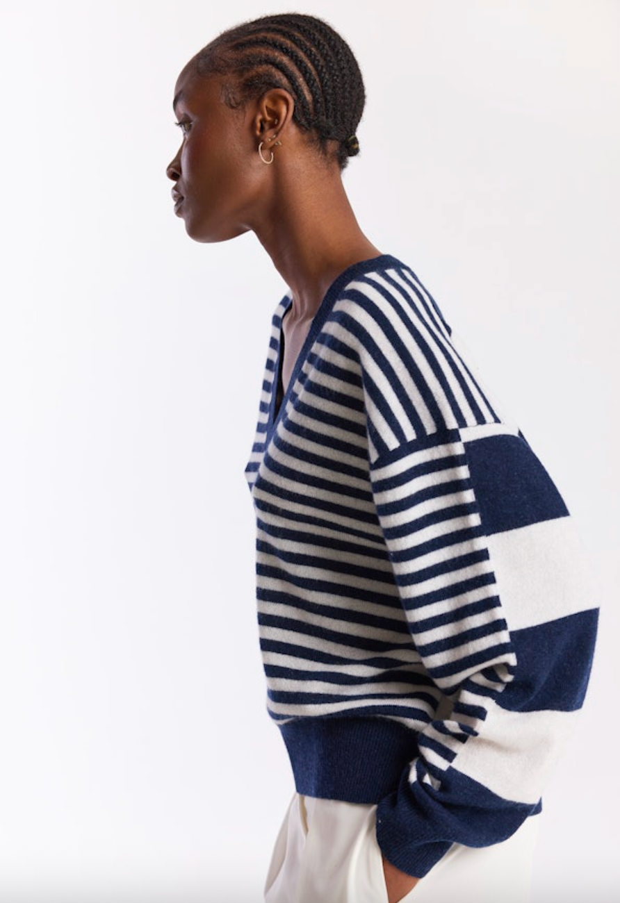 Woman wearing a blue and white striped sweater on a white background