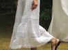 White lace dress with a blurred natural background