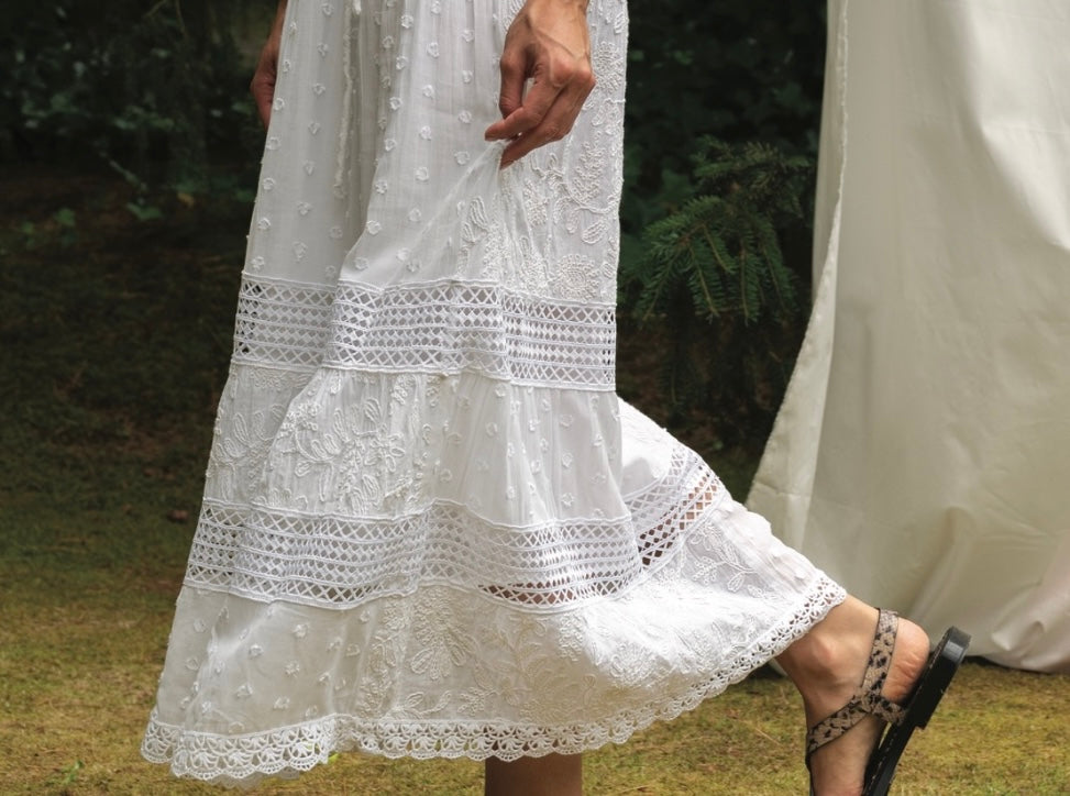 White lace dress with a blurred natural background