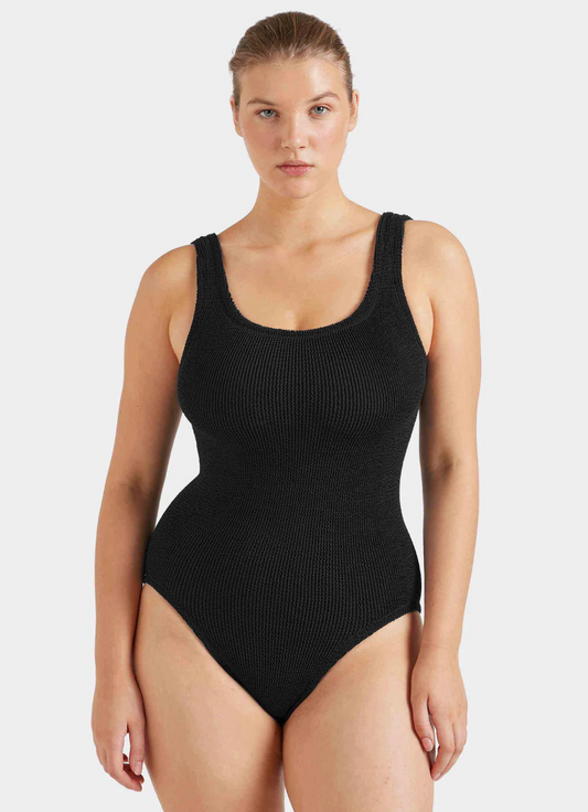 Black one piece swimsuit on model on white background 