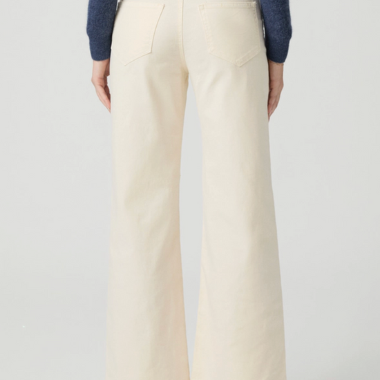 Cream jeans from the rear on a model on a white background