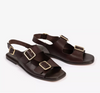 a pair of dark brown sandals on a white background