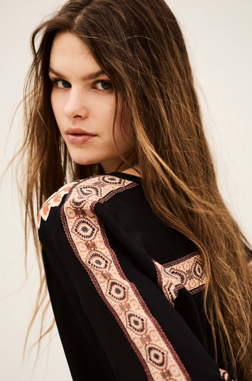 dark brown button down blouse with colourful paisley print from bash model close up