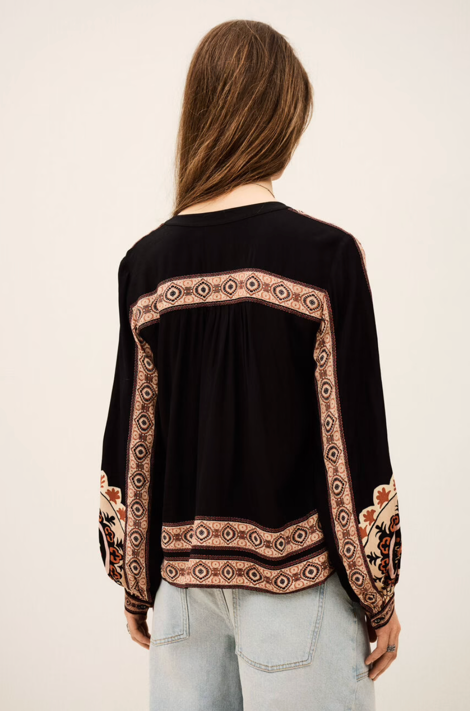 dark brown button down blouse with colourful paisley print from bash model model rear