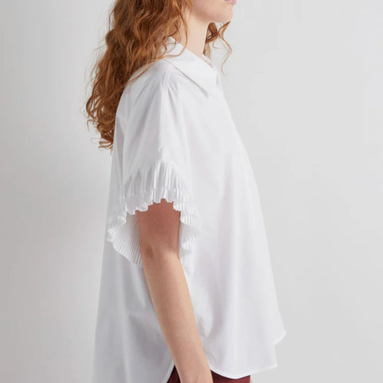 Side view of white shirt with pleated sleeve detail