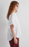 Side view of white shirt with pleated sleeve detail