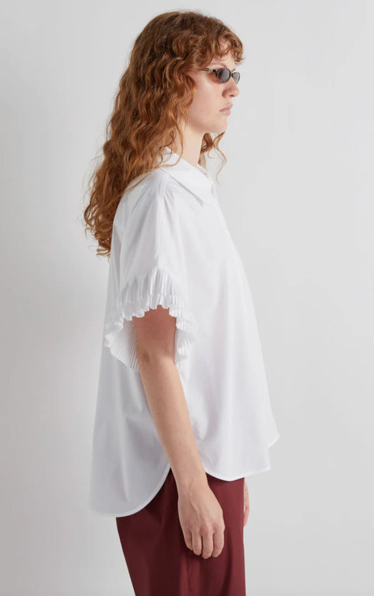 Side view of white shirt with pleated sleeve detail
