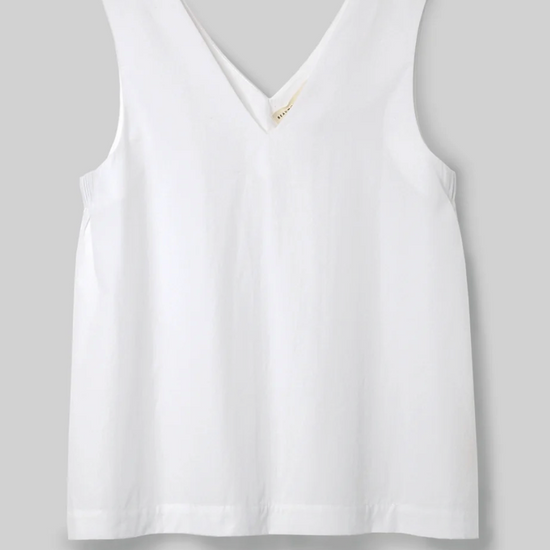 white v neck top on a light grey background