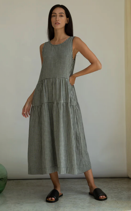 Woman wearing a checkered dress against a plain background in organic cotton