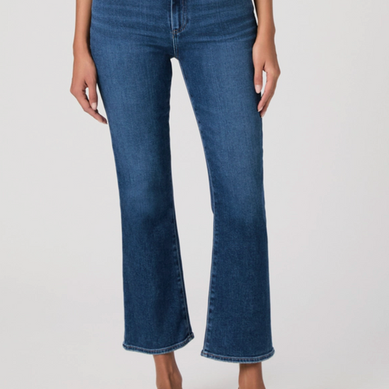 Blue jeans worn by a person on a white background