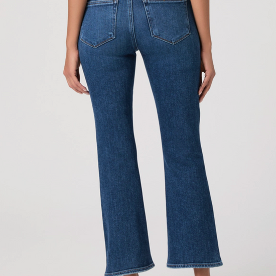 Blue jeans worn by a person on a white background