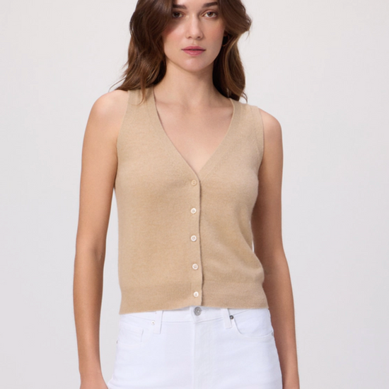 Woman wearing a beige sleeveless button-up top against a white background