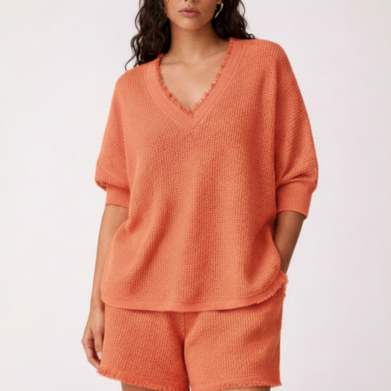 Woman wearing an orange outfit on a white background