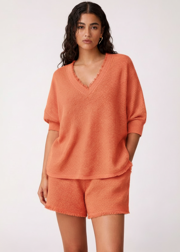 Woman wearing an orange outfit on a white background