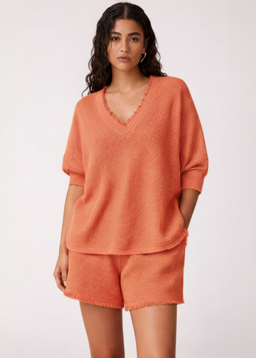 Woman wearing an orange outfit on a white background