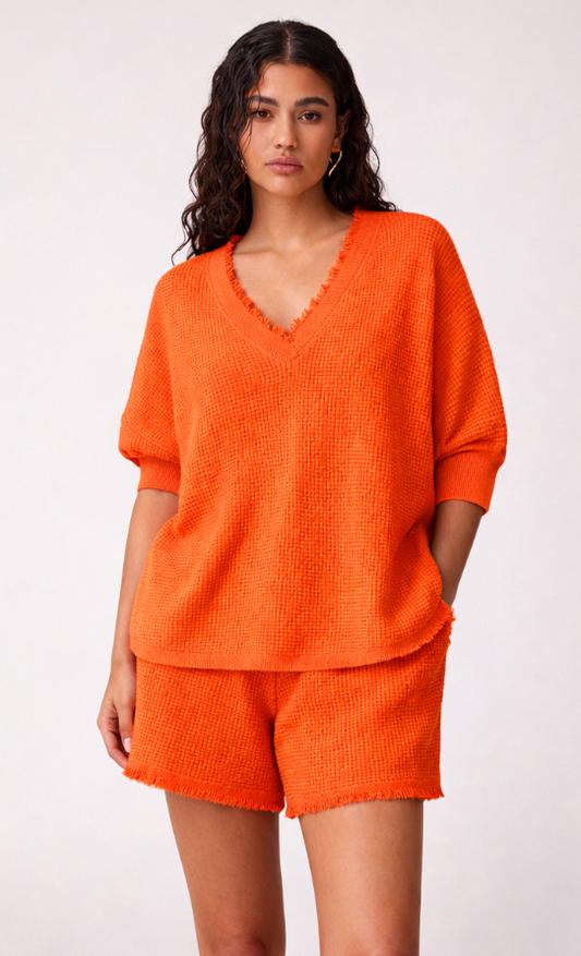 Woman wearing an orange outfit on a white background