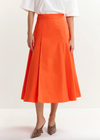 Bright orange skirt worn with white tee