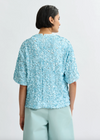 Rear view of pale blue sequin top