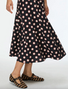 Black printed skirt worn with flat woven shoes