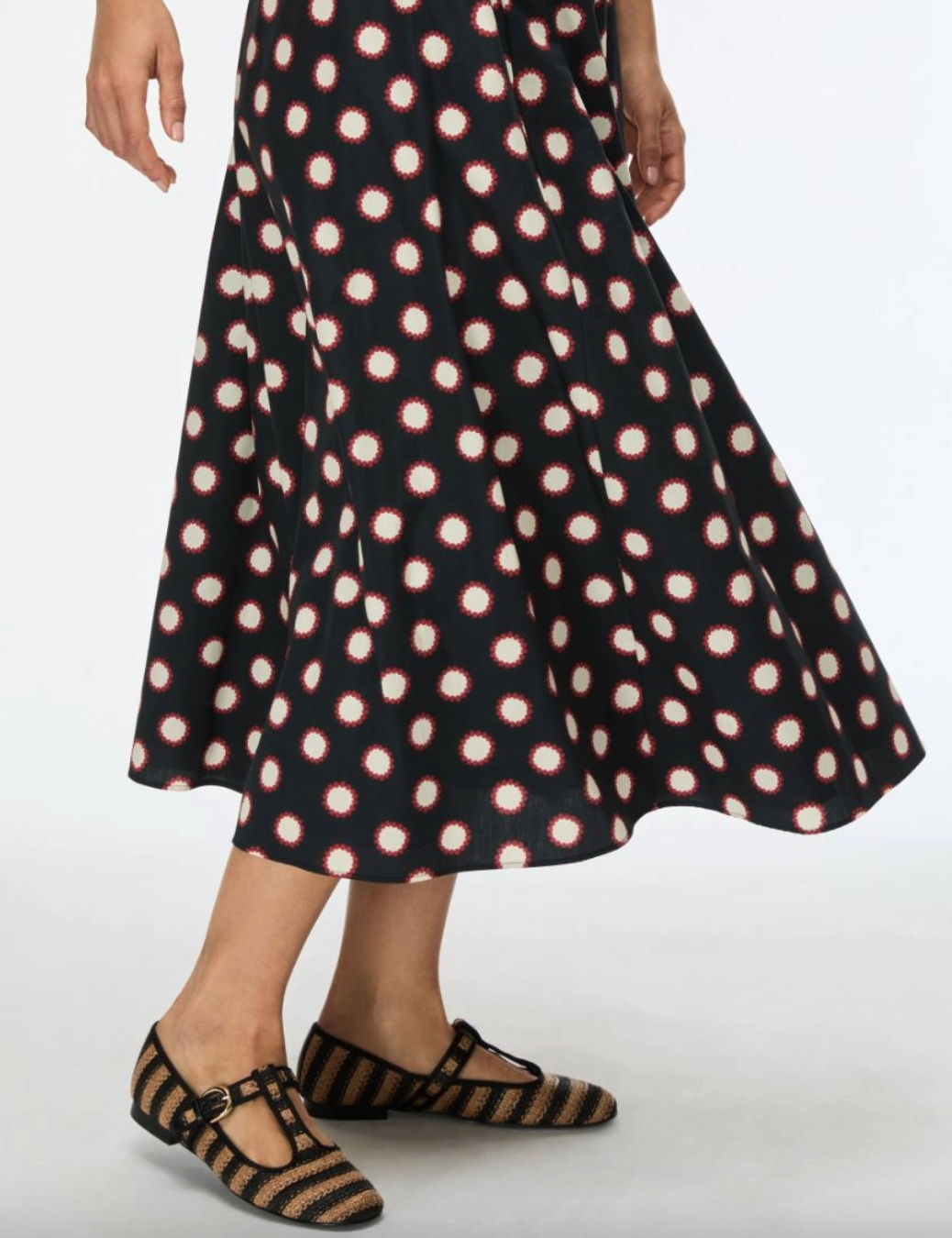 Black printed skirt worn with flat woven shoes
