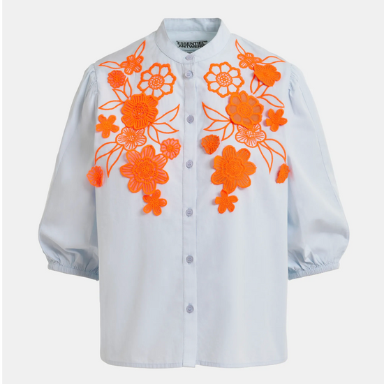 pale blue blouse with orange floral embroidery on a white background