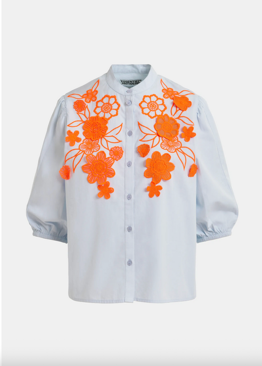 pale blue blouse with orange floral embroidery on a white background